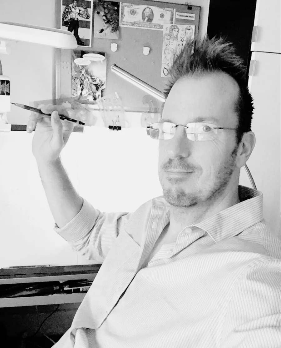 Mike Van Orden at his drawing desk, pencil in hand